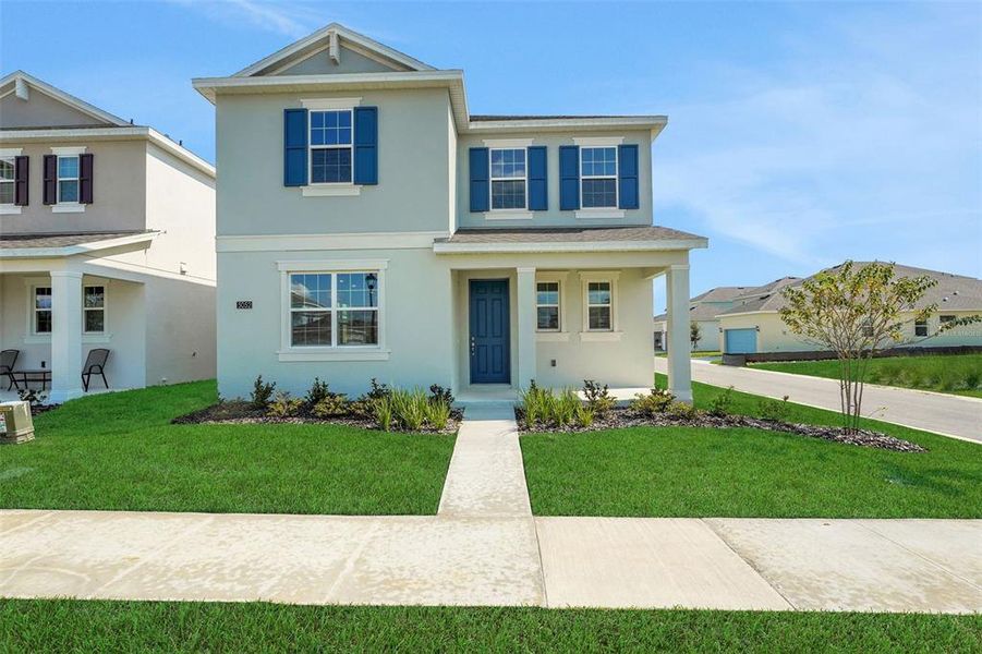 Front exterior of a new home in Crossroads at Kelly Park, Apopka, FL, highlighting curb appeal (Image 14).