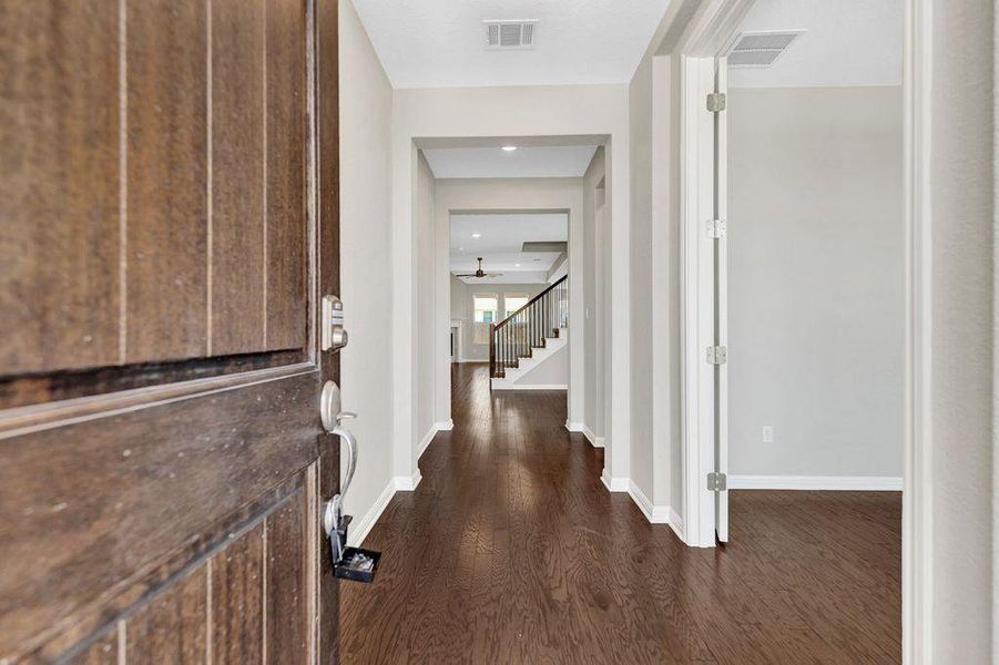 Foyer featuring dark wood-style floors and stairs Foyer featuring dark wood-style floors and stairs
