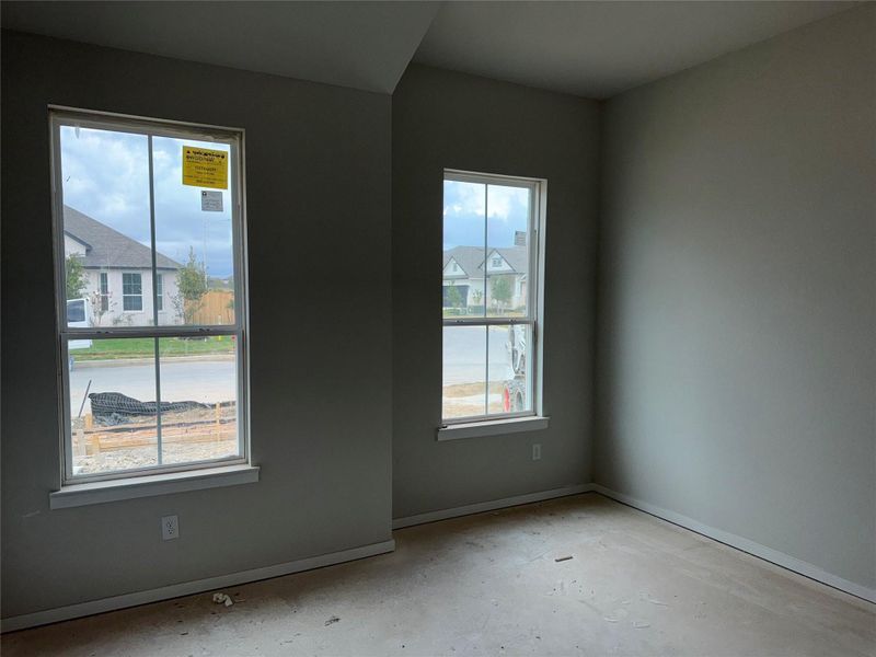 Unfurnished room featuring plenty of natural light and concrete floors Unfurnished room featuring plenty of natural light and concrete floors