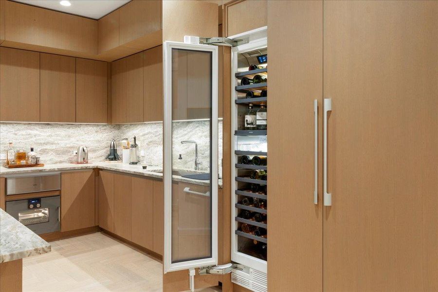 A showcase of fully integrated Gaggenau® refrigeration, including 36” refrigerator, 18” freezer and 18” wine column, all concealed within custom Rhode Partners millwork for a seamless, architectural look. The 3cm Fantasy Brown marble surfaces and built-in steam oven complete a kitchen designed for both elevated entertaining and everyday ease.