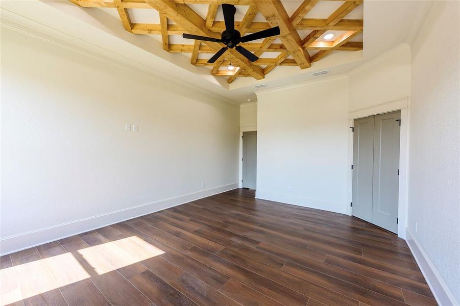 Spare room with coffered ceiling, dark wood-type flooring, crown molding, a ceiling fan, and recessed lighting Spare room with coffered ceiling, dark wood-type flooring, crown molding, a ceiling fan, and recessed lighting