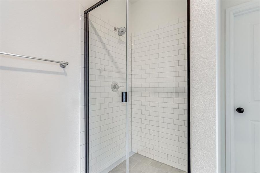 Bathroom featuring a shower with door