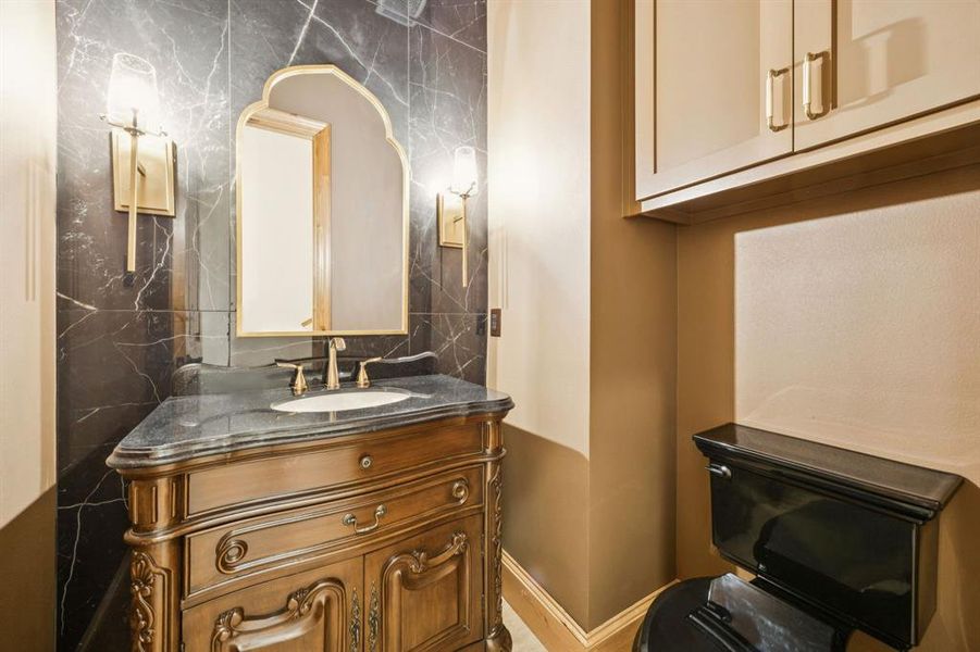 Half bath with vanity and baseboards