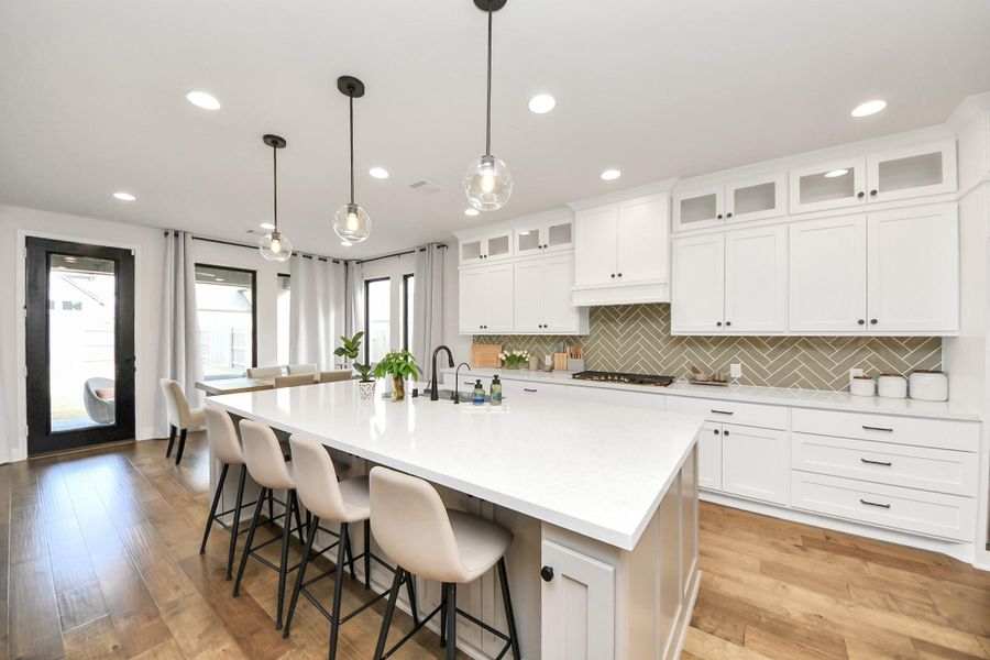 Bright kitchen layout with abundant cabinetry and prep space.