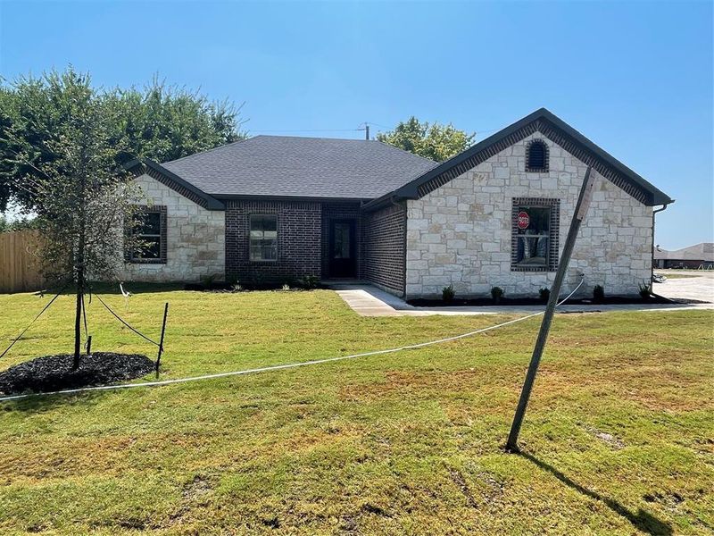 View of front of property with a front yard