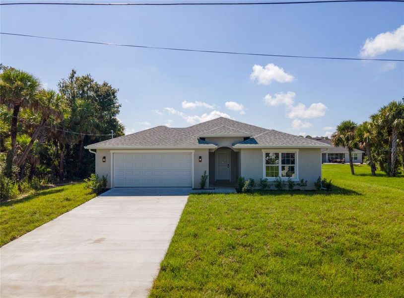 Front exterior of a new home in , North Port, FL, highlighting curb appeal (Image 1). Front exterior of a new home in , North Port, FL, highlighting curb appeal (Image 1).