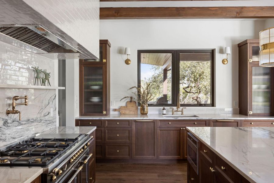 Gourmet luxury kitchen with Fantasy Luxe Quartzite Countertops, Bertazzoni Heritage Range, and Walnut Cabinets