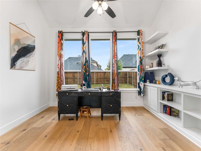 Home office with built in shelving and cabinets.