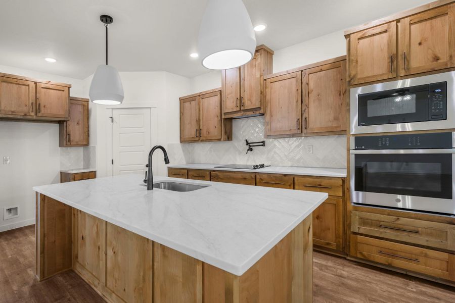 A well-appointed kitchen showcasing elegant wooden cabinetry and modern stainless steel appliances.