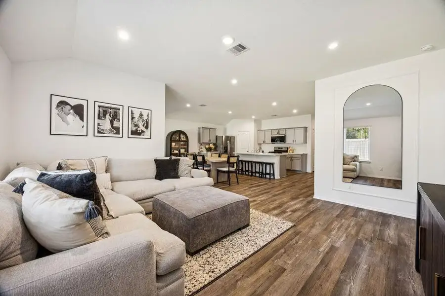 Spacious and inviting living area with modern finishes, blending seamlessly into the open-concept kitchen and dining space. Perfect for relaxing or entertaining. Spacious and inviting living area with modern finishes, blending seamlessly into the open-concept kitchen and dining space. Perfect for relaxing or entertaining.