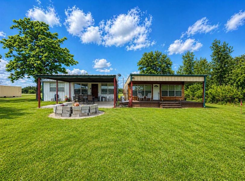 Back patio and deck with fire pit. Back patio and deck with fire pit.