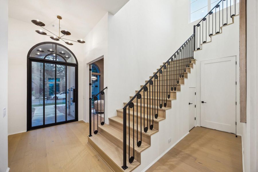 Entrance with a Steel Front Pivot Door. Open Staircase with Oval Spindles & Flat Steel Handrail. Entrance with a Steel Front Pivot Door. Open Staircase with Oval Spindles & Flat Steel Handrail.
