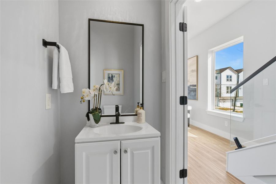 Stylish powder bath featuring a modern vanity, matte black fixtures, and clean finishes.Perfectly placed for guests with a bright, contemporary feel.