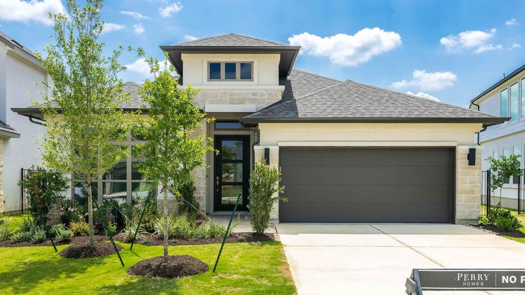 View of front facade with stucco siding, driveway, a shingled roof, and stone siding View of front facade with stucco siding, driveway, a shingled roof, and stone siding
