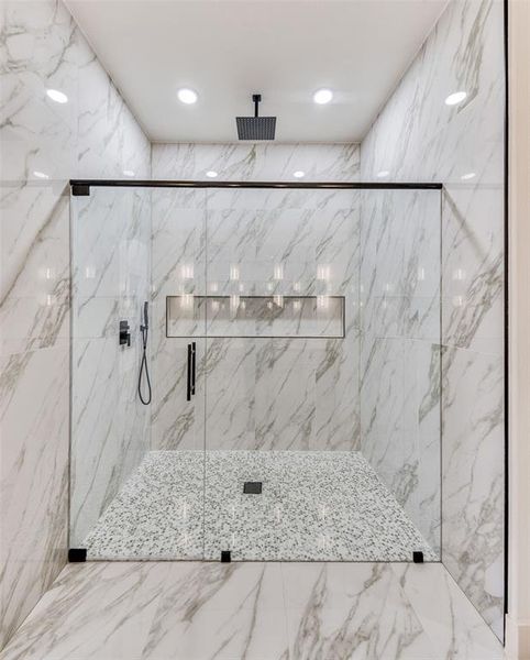 Full bath featuring a marble finish shower and recessed lighting