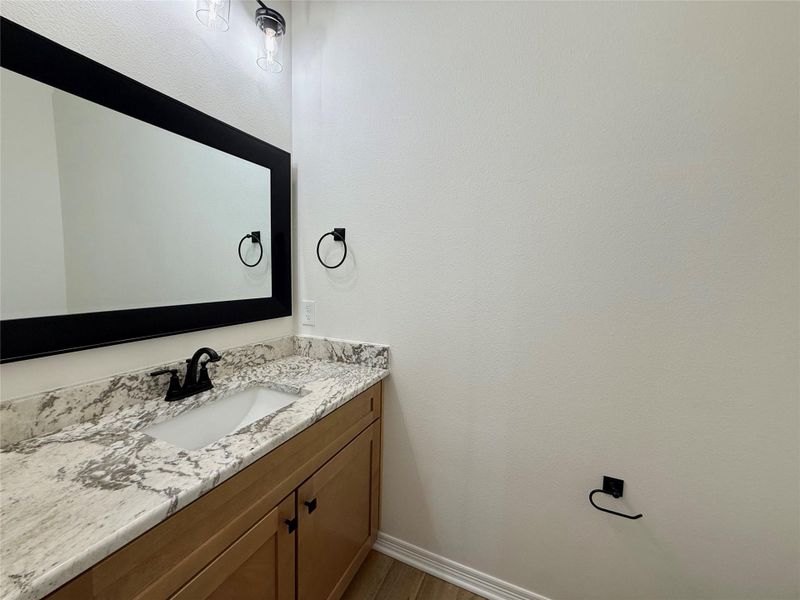 Bathroom featuring vanity and dark wood-style floors