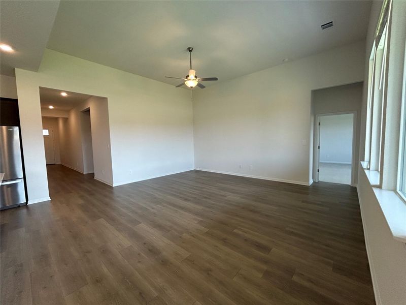 Unfurnished dining area with dark wood-style floors, ceiling fan, and recessed lighting Unfurnished dining area with dark wood-style floors, ceiling fan, and recessed lighting