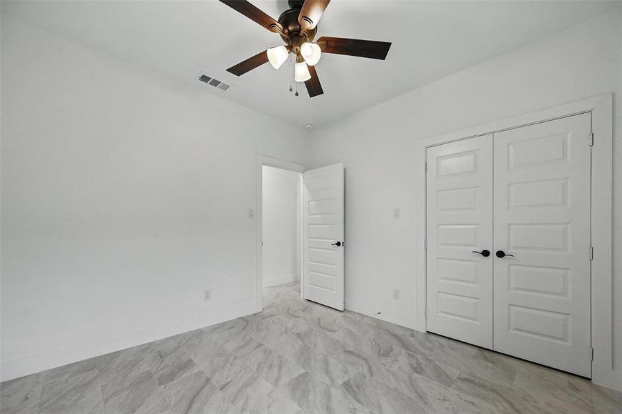 Unfurnished bedroom with a closet and ceiling fan
