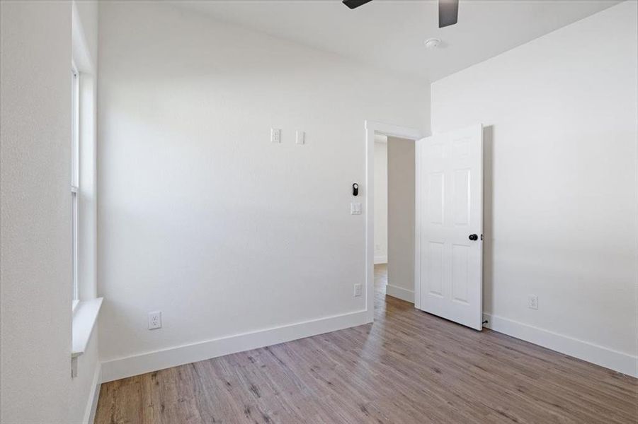 Spare room featuring wood-type flooring and ceiling fan