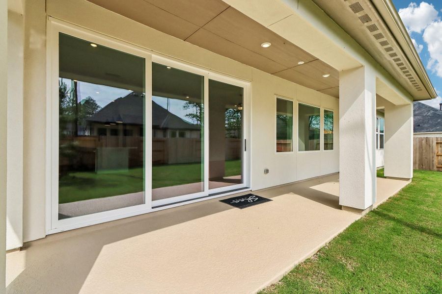Exterior details and patio area of a home in Woodhavyn 60', Magnolia (Image 3).