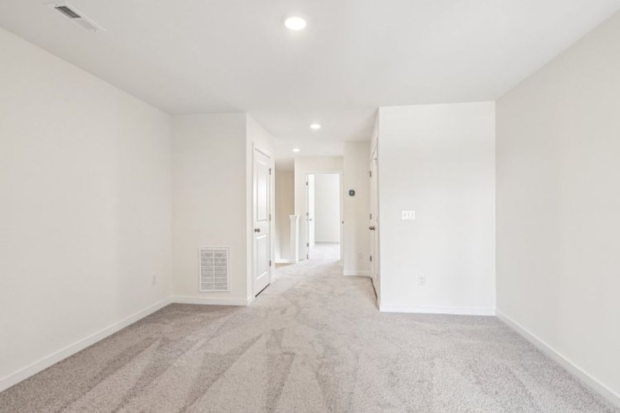 A long hallway with white walls.