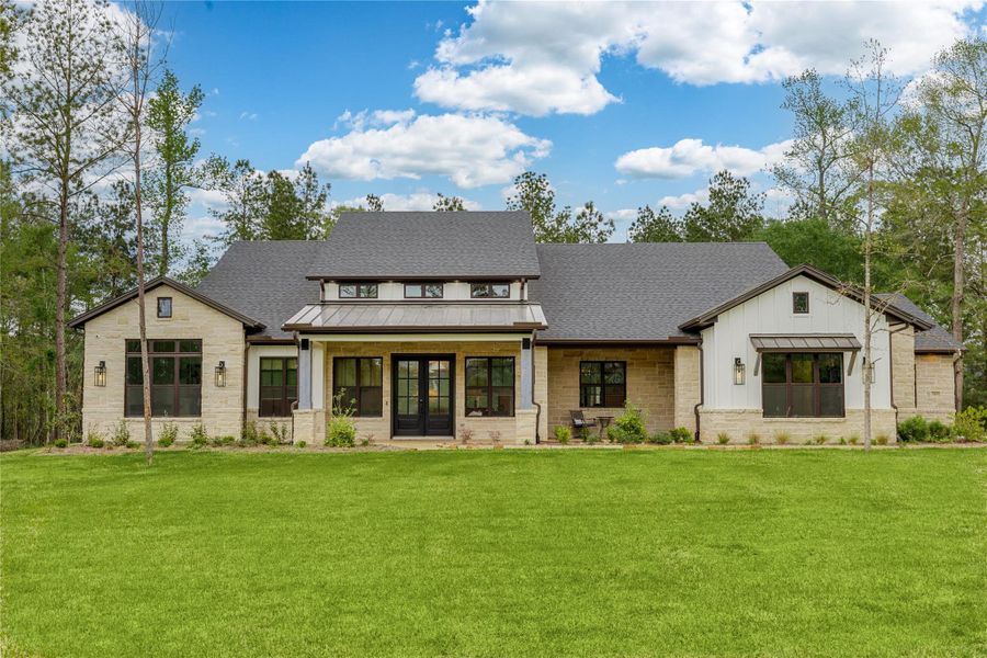 Inviting, charming and elegant.  Oversized front porch with double decorative glass doors, and subtle landscaping complimenting the front elevation.  The walkway has stamped concrete cleverly laid in a brick design.  Hinkley glass lanterns add ambience to this 4308 sq. ft.