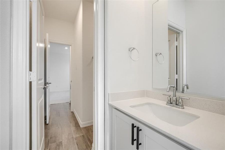 Bathroom featuring vanity and light wood finished floors Bathroom featuring vanity and light wood finished floors