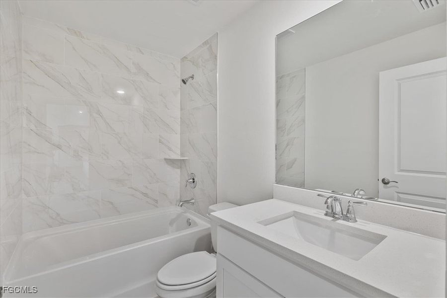 Bathroom featuring  shower combination and vanity