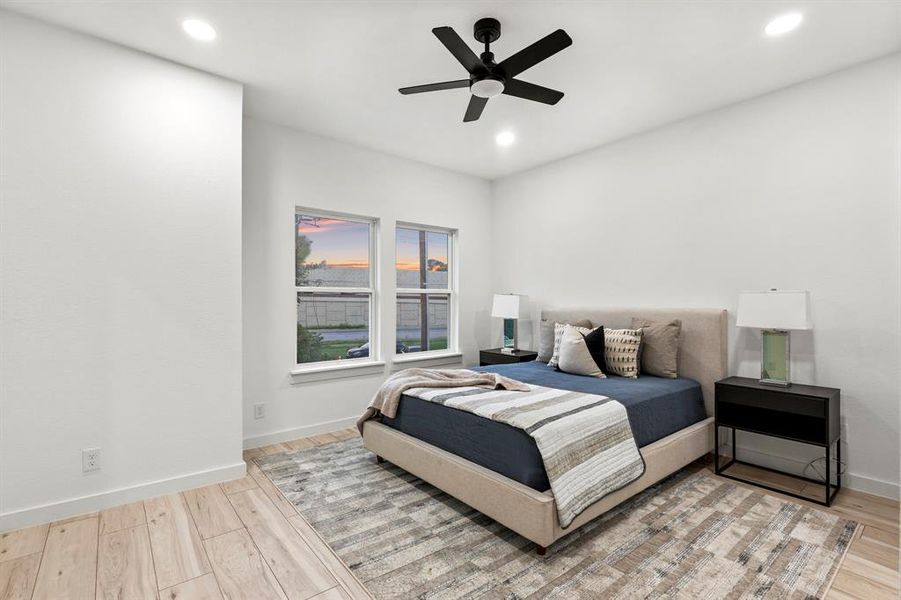 Bedroom featuring wood finished floors, recessed lighting, baseboards, and ceiling fan Bedroom featuring wood finished floors, recessed lighting, baseboards, and ceiling fan