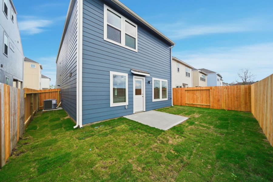 A blue house with a fence around it. A blue house with a fence around it.