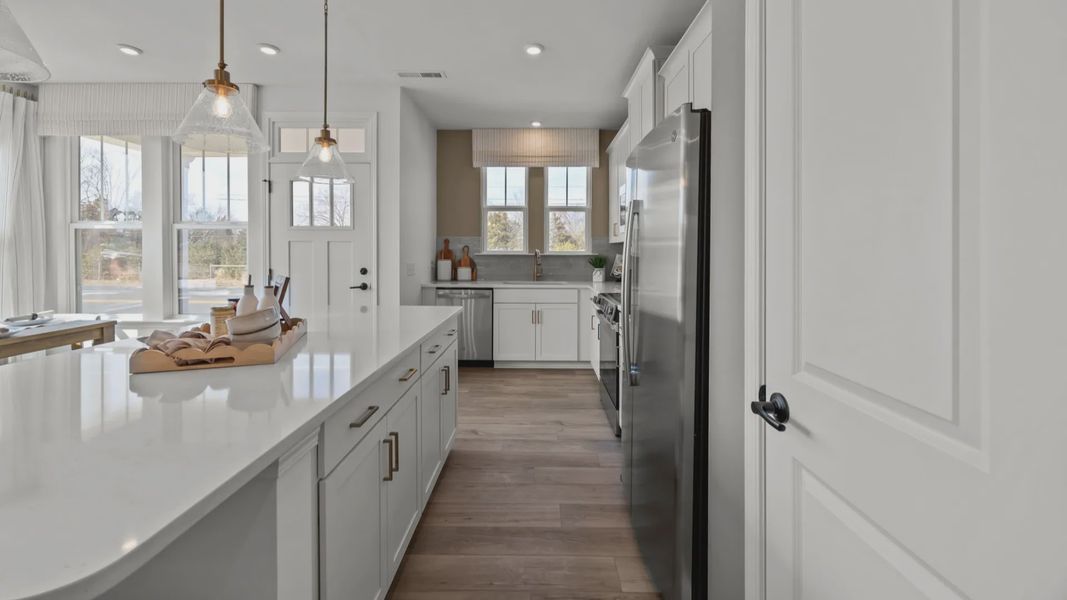 The Rochester Plan by DRB homes kitchen with island and modern features in Charlotte, NC.