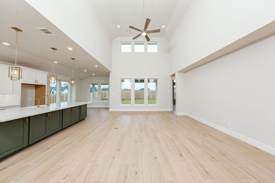 Enjoy an open, airy living experience in the GREAT ROOM where oversized windows flood the entire space with abundant natural light and frame a picturesque view of the serene backyard. A large ceiling fan provides comfort all year long. The integrated wall niche offers valuable recessed storage and display space without encroaching on the room's floor plan.