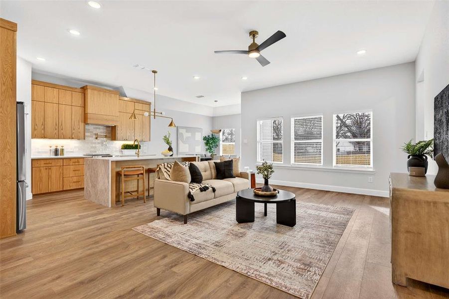 Living room featuring light wood-style flooring and a ceiling fan