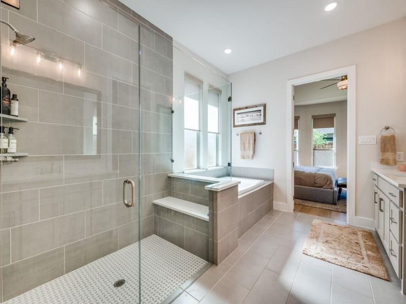 Ensuite bathroom featuring a shower stall, tile patterned flooring, vanity, a garden tub, and recessed lighting