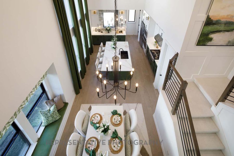 Living area featuring a chandelier, wood finished floors, stairway, and a decorative wall