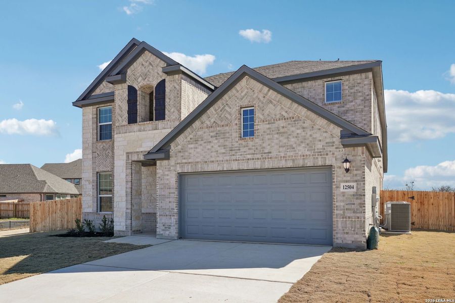 Front exterior of a new home in Carmel Ranch, Schertz, TX, highlighting curb appeal (Image 1). Front exterior of a new home in Carmel Ranch, Schertz, TX, highlighting curb appeal (Image 1).