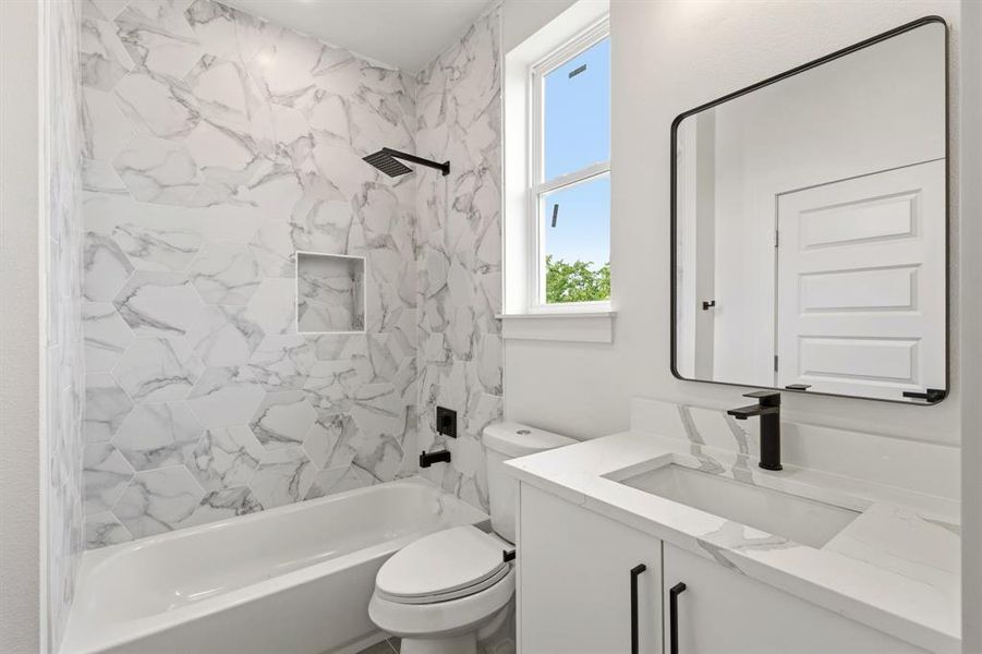 Bathroom featuring a white vanity with a rectangular sink, a black faucet, and a black-framed mirror