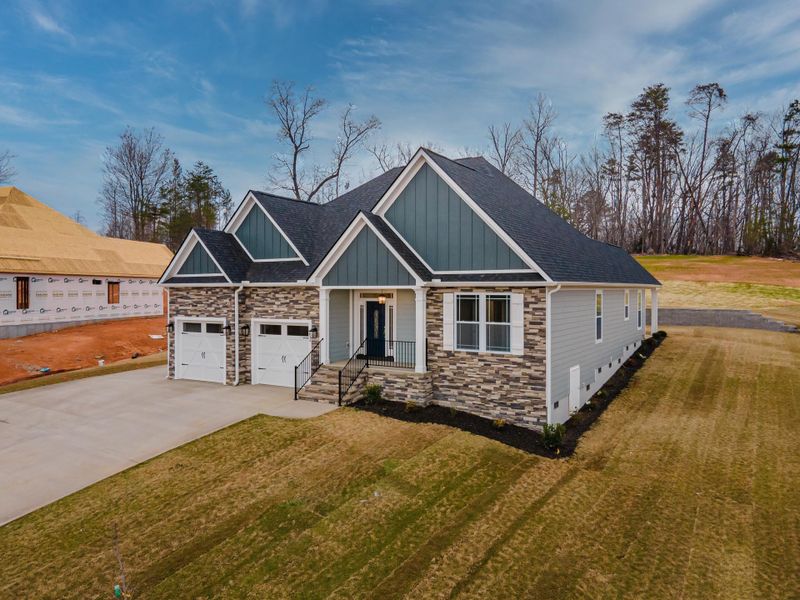 Representative exterior photo of a completed home built from the Roosevelt Elite by Enchanted Homes in Pointe Summit, Slater-Marietta, SC (Image 26).