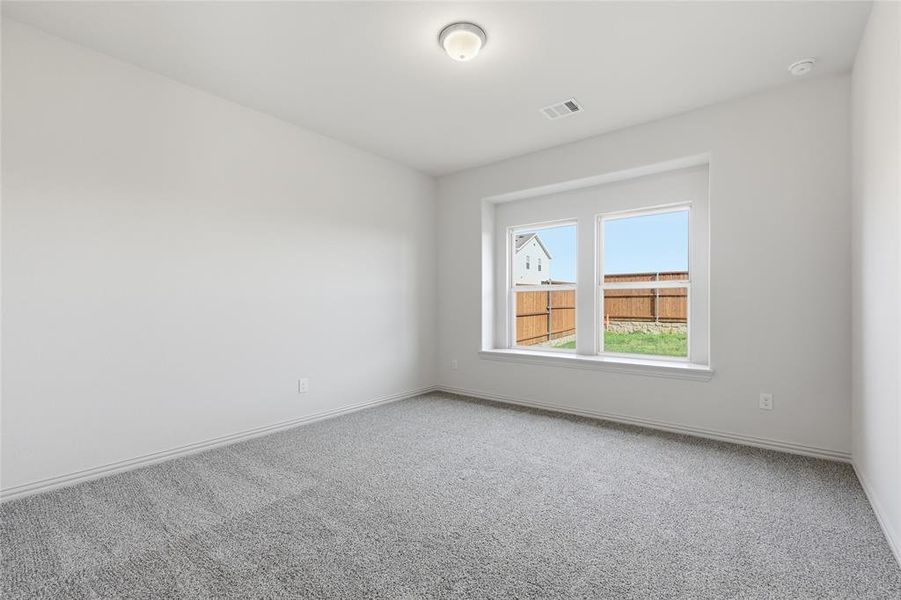 Bright interior space featuring a double window, light gray carpeting, neutral wall tones, and a ceiling-mounted light fixture