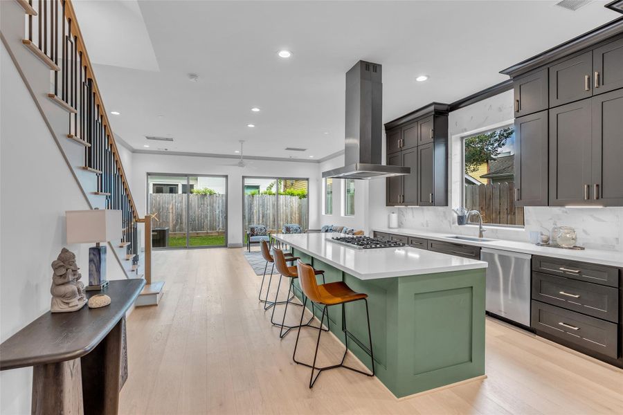 It provides plenty of cabinet storage, along with a walk-in pantry tucked into the corner for added convenience and organization.