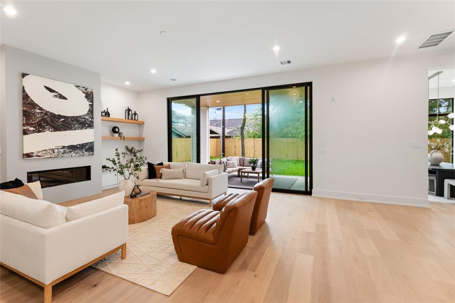 Spectacular 10-foot sliding glass doors anchor the living room with their clean lines and impressive scale. The seamless glass panels flood the interior with natural light while offering effortless indoor-outdoor entertaining possibilities.