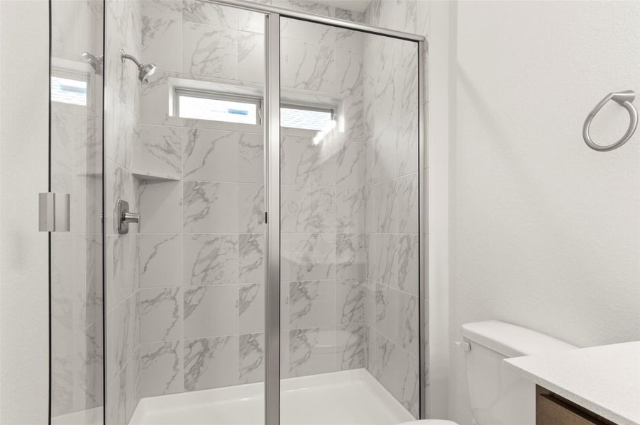 Bathroom with a shower stall and vanity