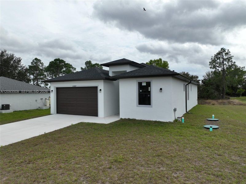 Front exterior of a new home in , Lehigh Acres, FL, highlighting curb appeal (Image 17).
