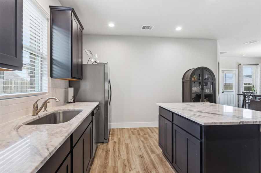 This modern kitchen features sleek cabinetry, elegant countertops, and ample natural light, offering a perfect blend of style and functionality. This modern kitchen features sleek cabinetry, elegant countertops, and ample natural light, offering a perfect blend of style and functionality.