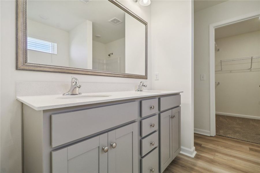 This primary bathroom features a dual vanity, slee This primary bathroom features a dual vanity, slee