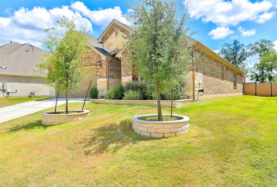 View of yard with driveway and an attached garage