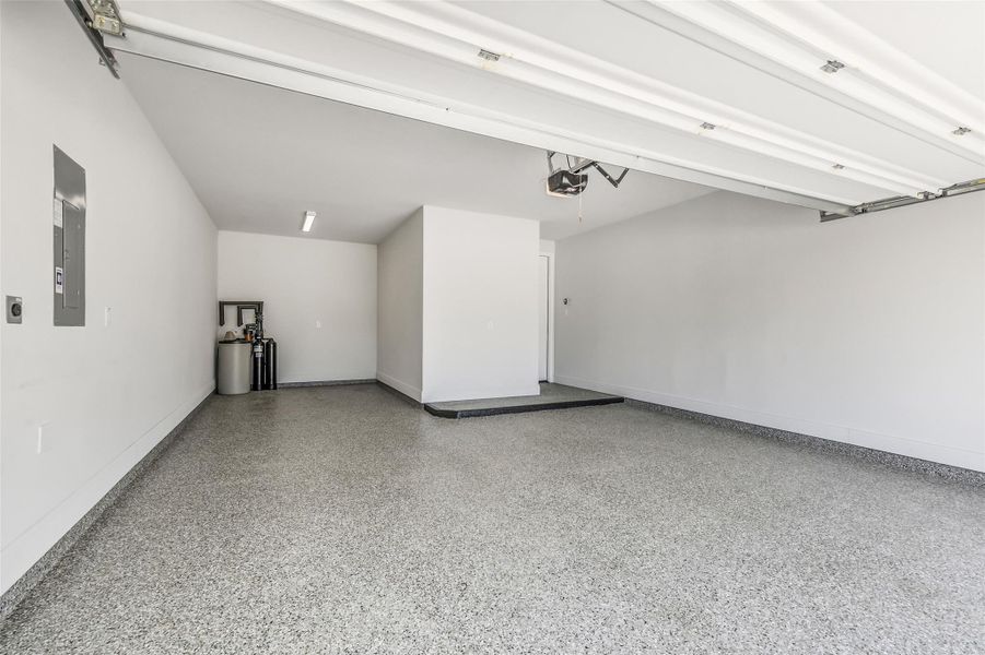 The garage has epoxy flooring plus has space for golf cart storage. The garage door has overhead opener. A water softener system has been installed in the garage. The garage has epoxy flooring plus has space for golf cart storage. The garage door has overhead opener. A water softener system has been installed in the garage.