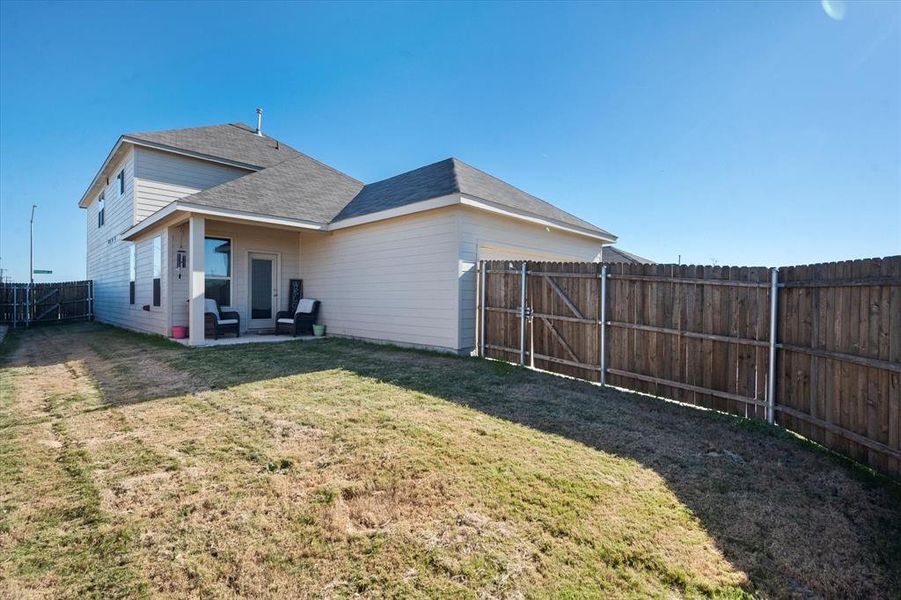 Back of house featuring a yard and a patio