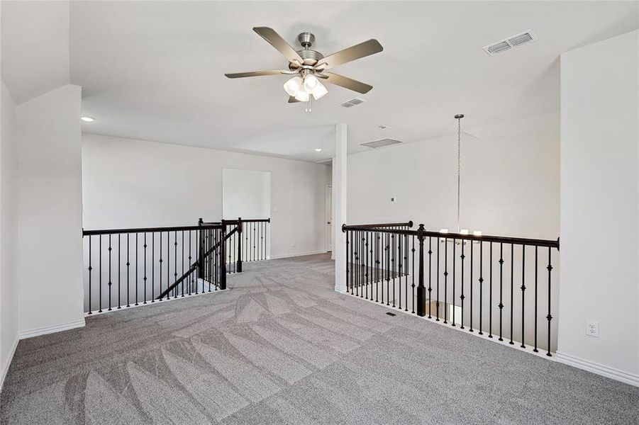 Unfurnished room with light carpet and ceiling fan