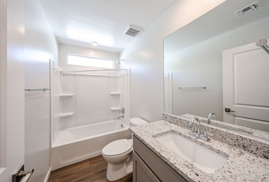 A bathroom with a marble countertop.